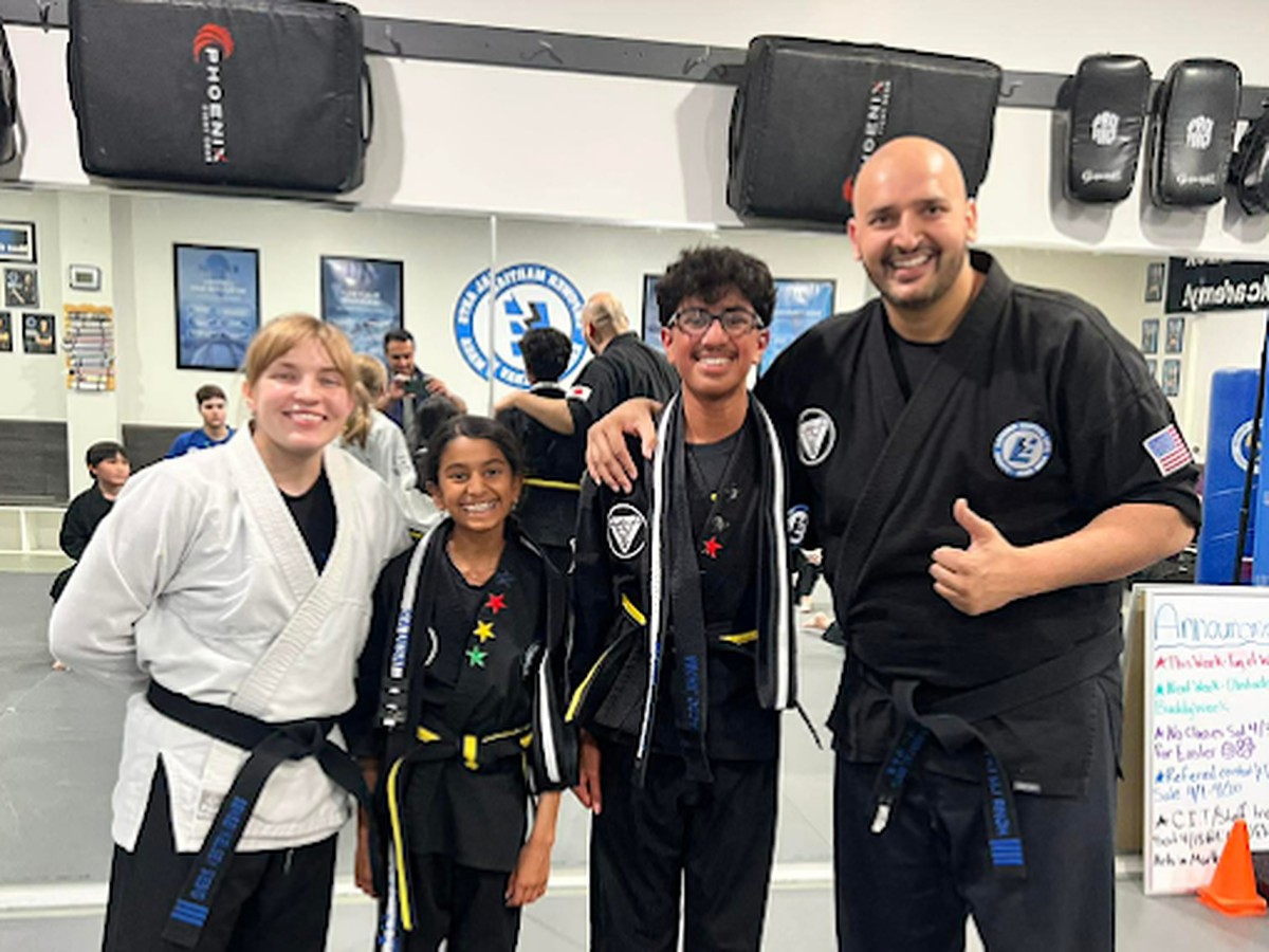 Empower Martial Arts kids karate students ages 7 to 12 with their instructor after class